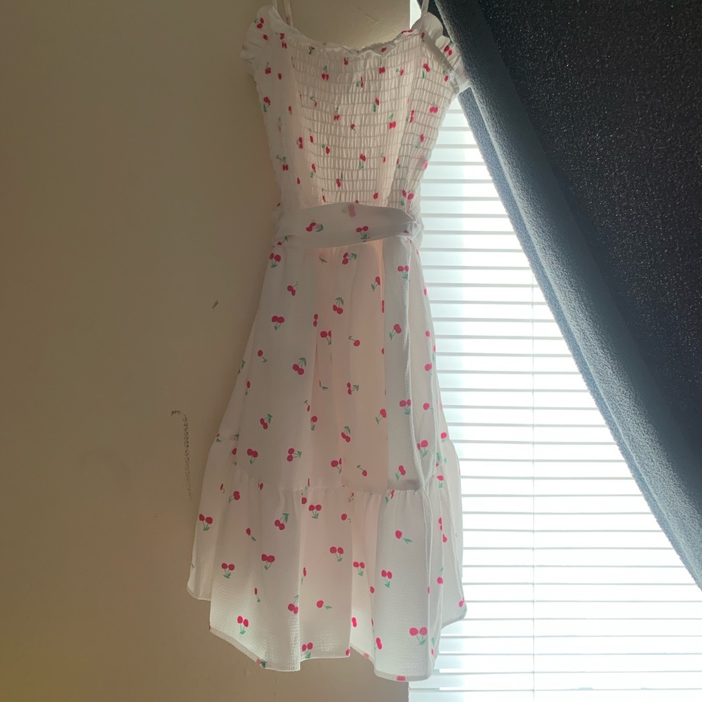 Medium size white dress with cherries on it. Brand new never worn.